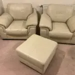 Furniture Village Cream leather two seater sofa , two armchairs and a footstool.