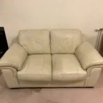 Furniture Village Cream leather two seater sofa , two armchairs and a footstool.