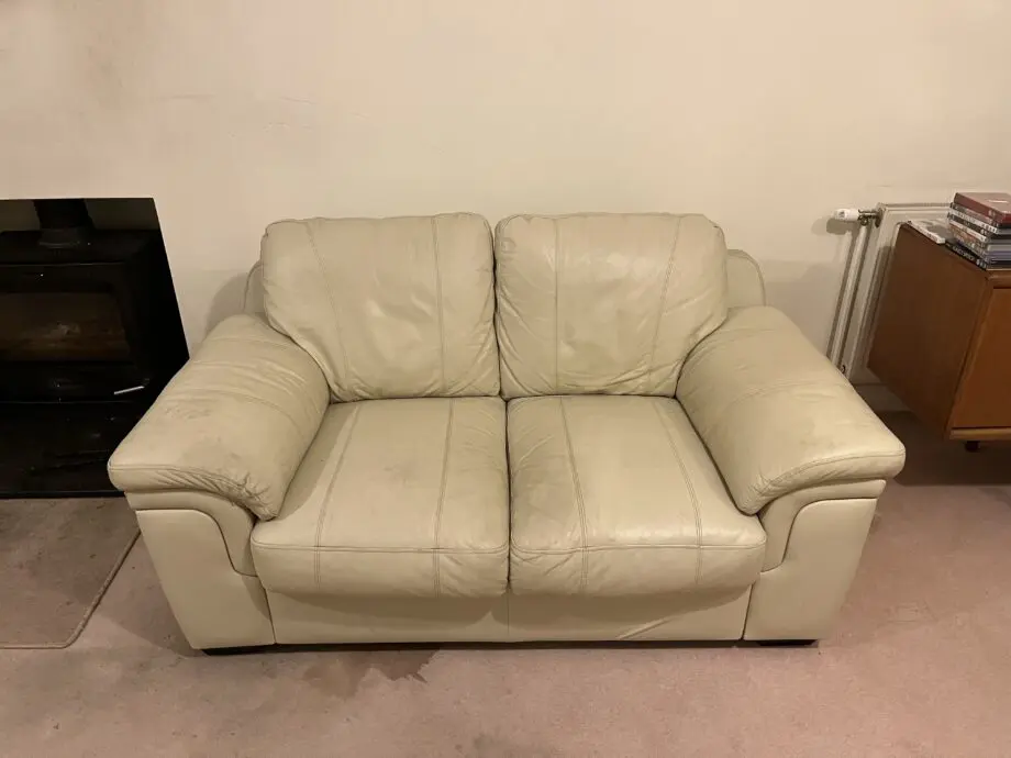 Furniture Village Cream leather two seater sofa , two armchairs and a footstool.