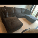 Black velvet 4 seater sofa with 2 foot stools