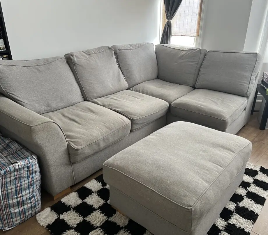 Grey corner sofa with footstool