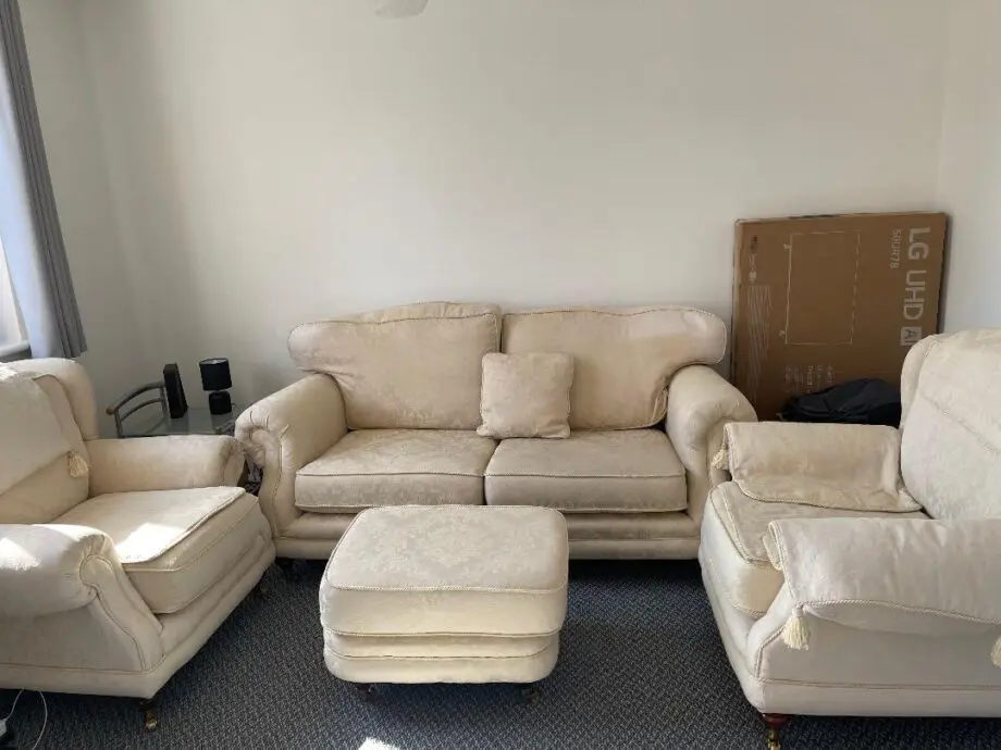 Cream color 4 seater sofa with footstool.