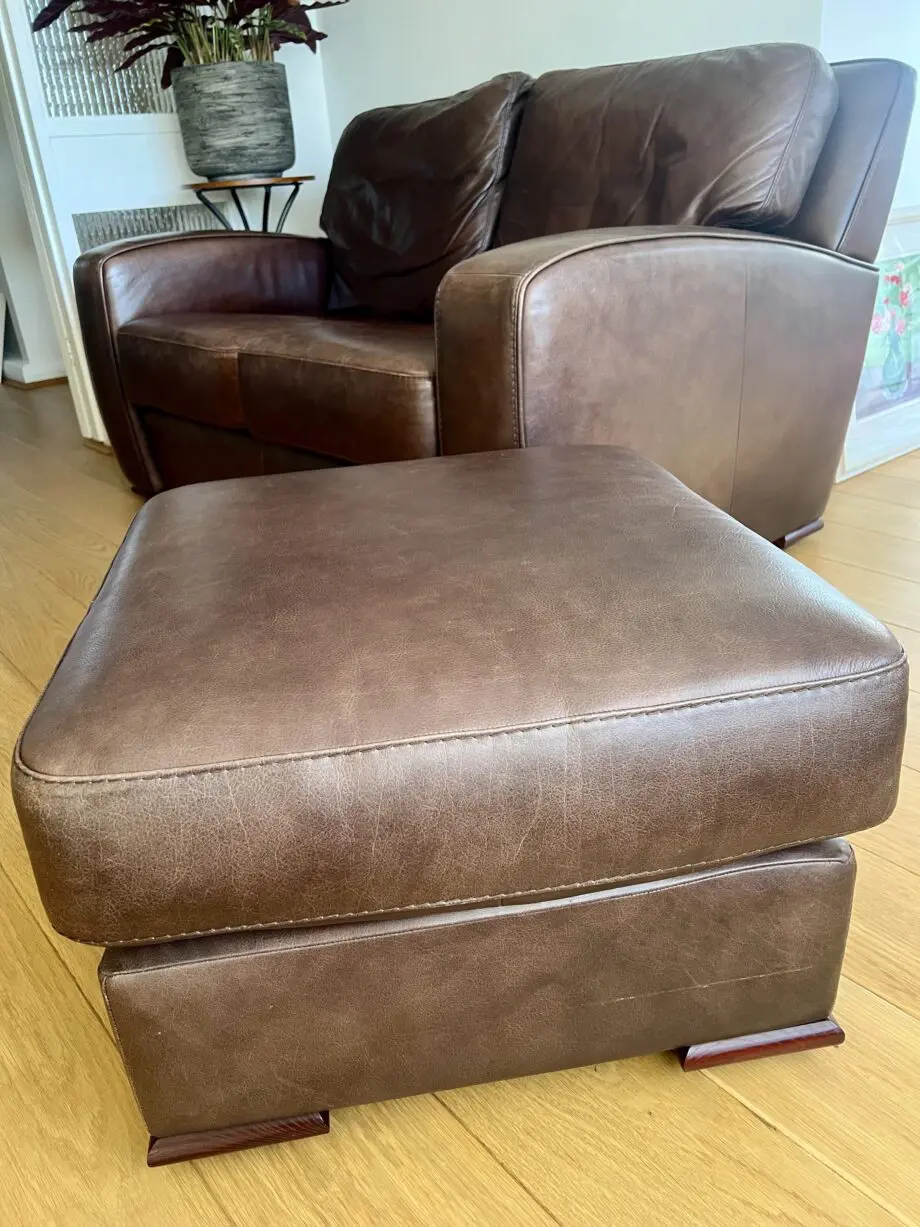 2 high quality leather sofas and footstool made by David Paine Associates for John Lewis. Style is Baltimore a modern interpretation of a retro classic