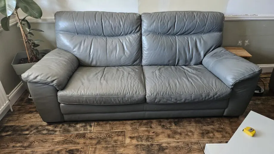 2 Grey leather 2 seater sofas with poof
