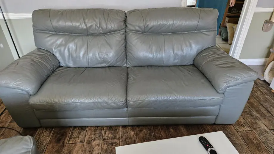 2 Grey leather 2 seater sofas with poof