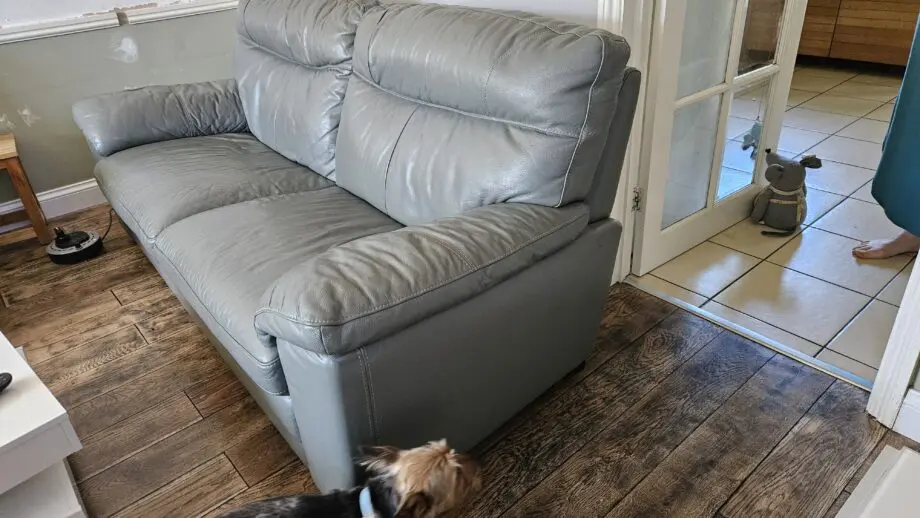2 Grey leather 2 seater sofas with poof
