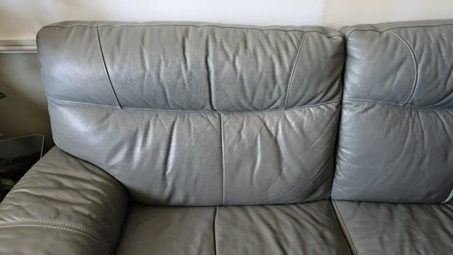 2 Grey leather 2 seater sofas with poof