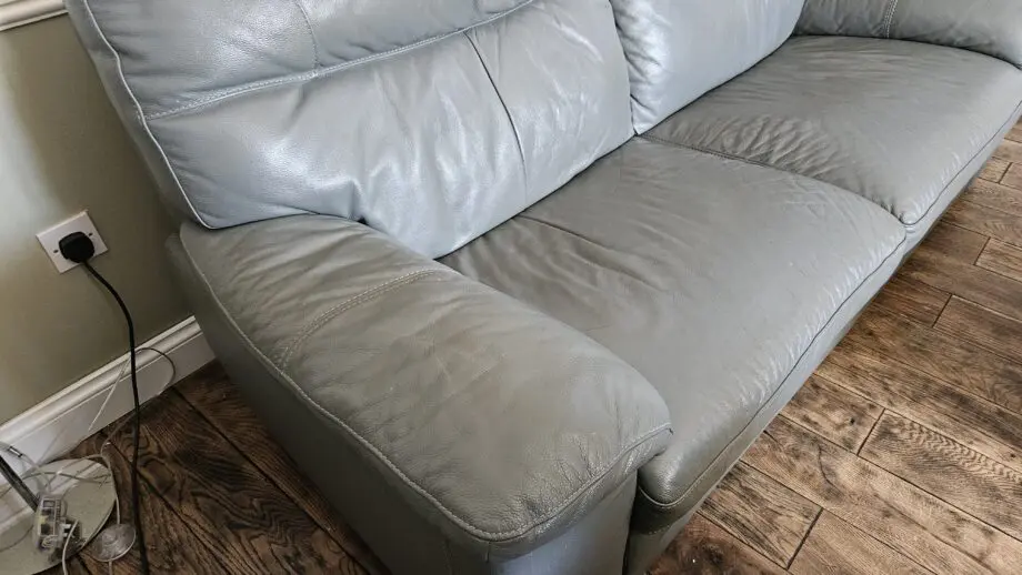 2 Grey leather 2 seater sofas with poof