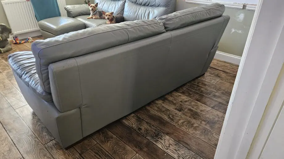 2 Grey leather 2 seater sofas with poof