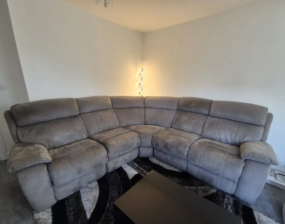 Grey, corner, reclining sofa for sale.