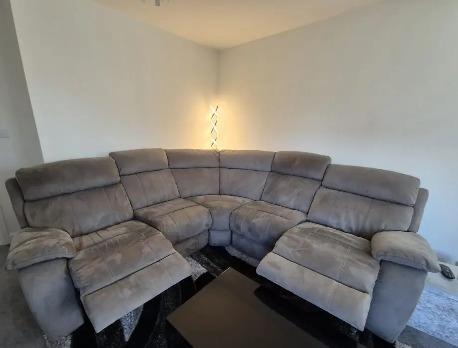 Grey, corner, reclining sofa for sale.