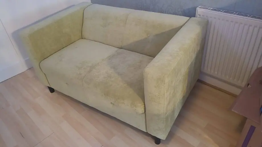 Green two seater sofa