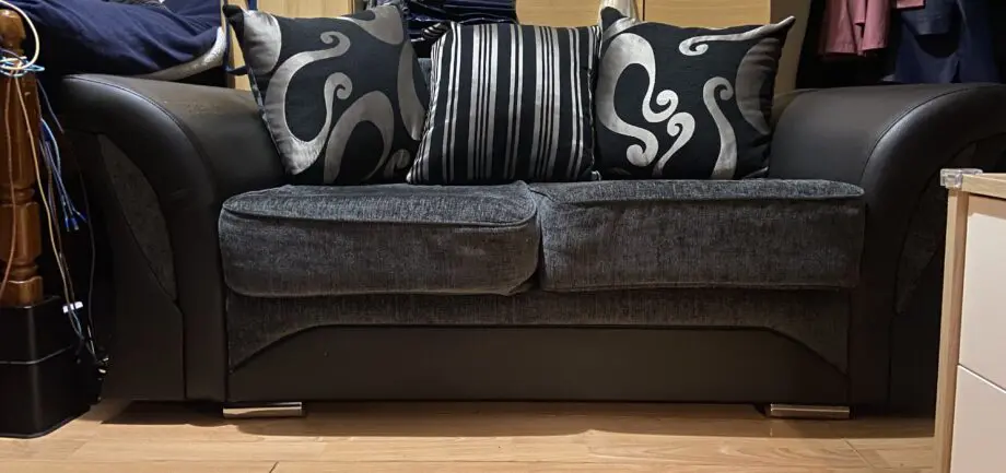 Unknown + black and charcoal cushion + two seated sofa