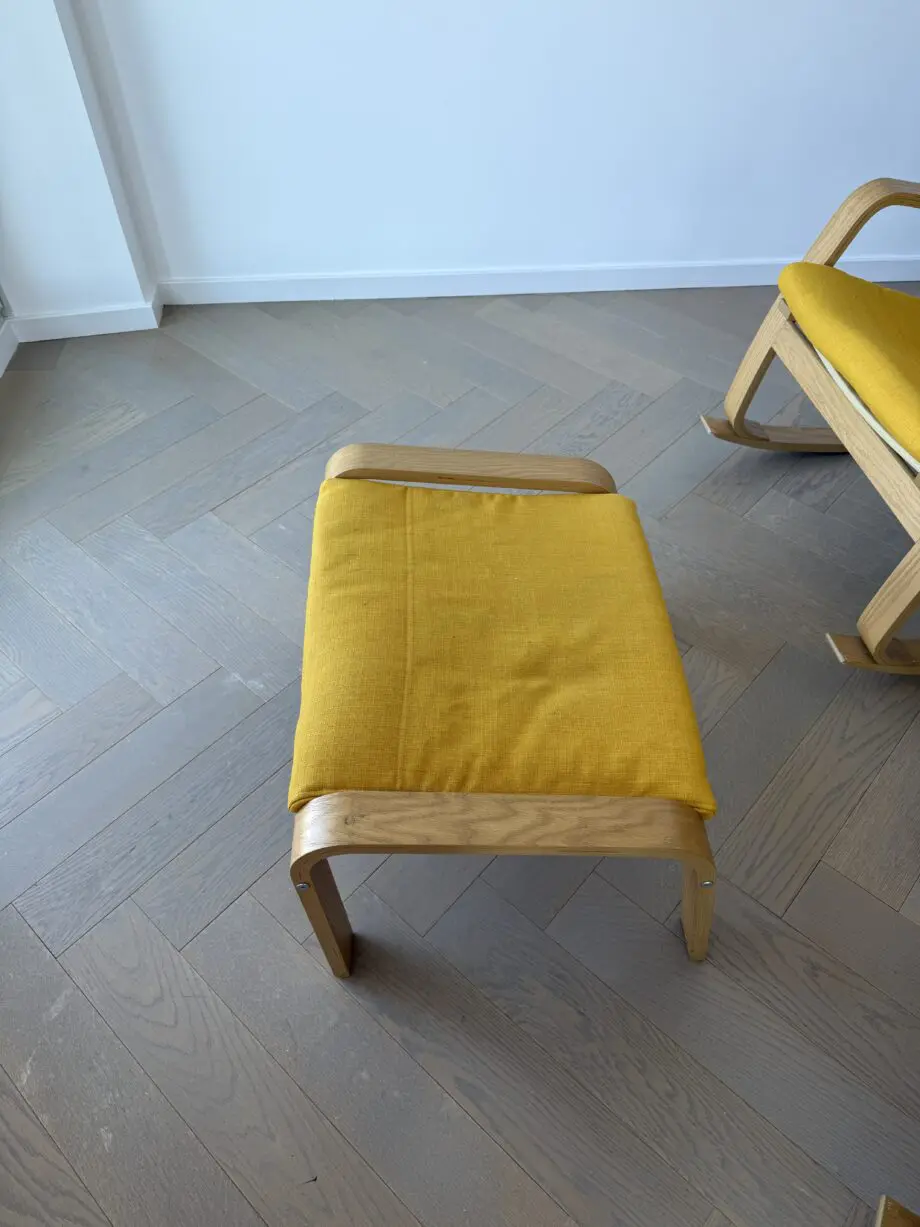 IKEA yellow Poang rocking chair and foot stool