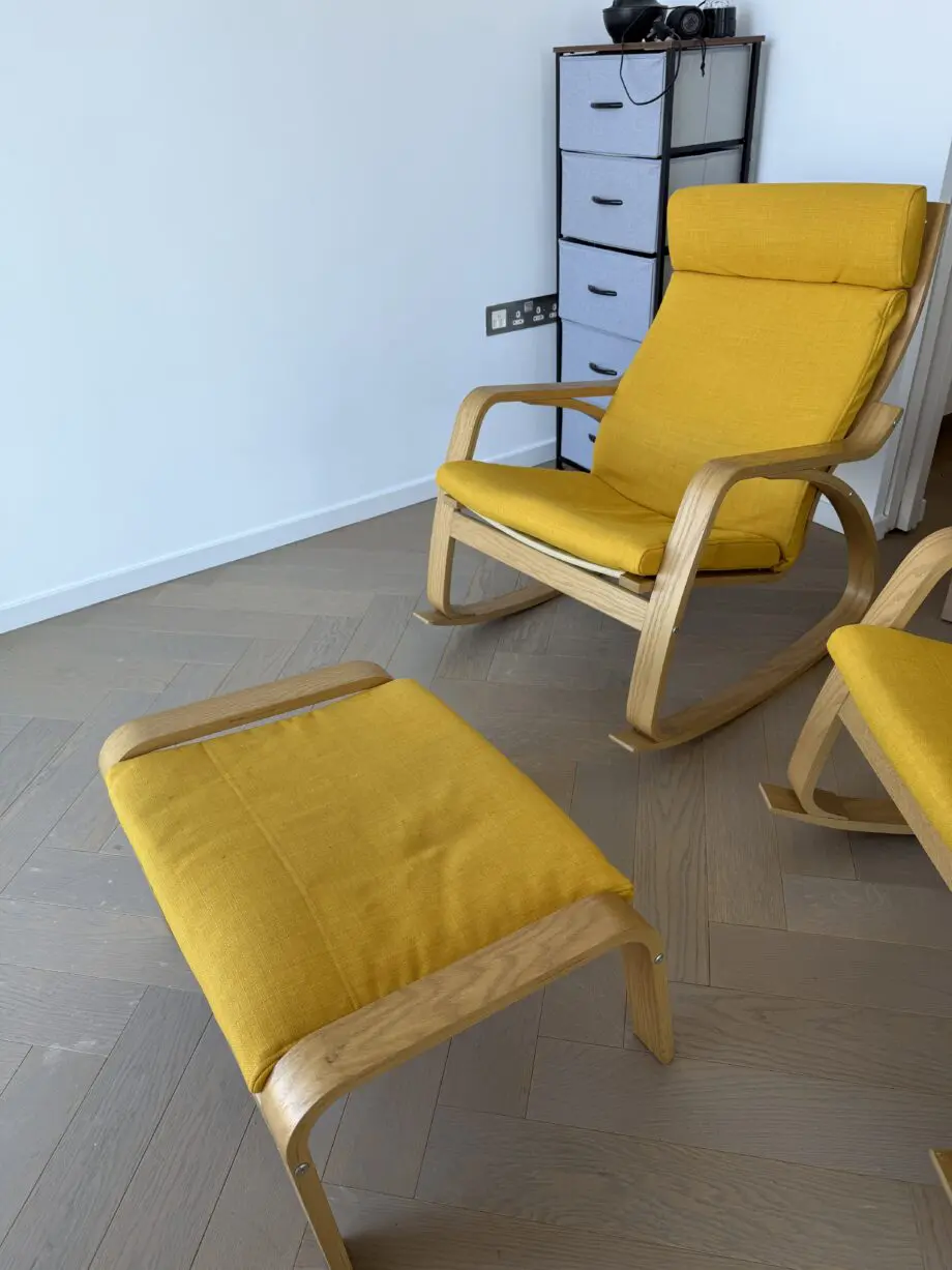 IKEA yellow Poang rocking chair and foot stool