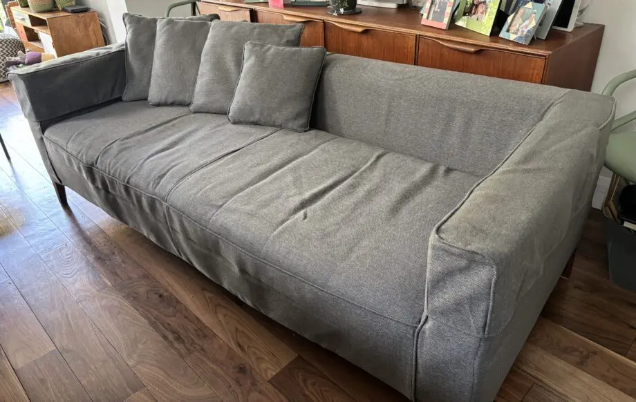 Dwell grey sofa with plumbs slip cover