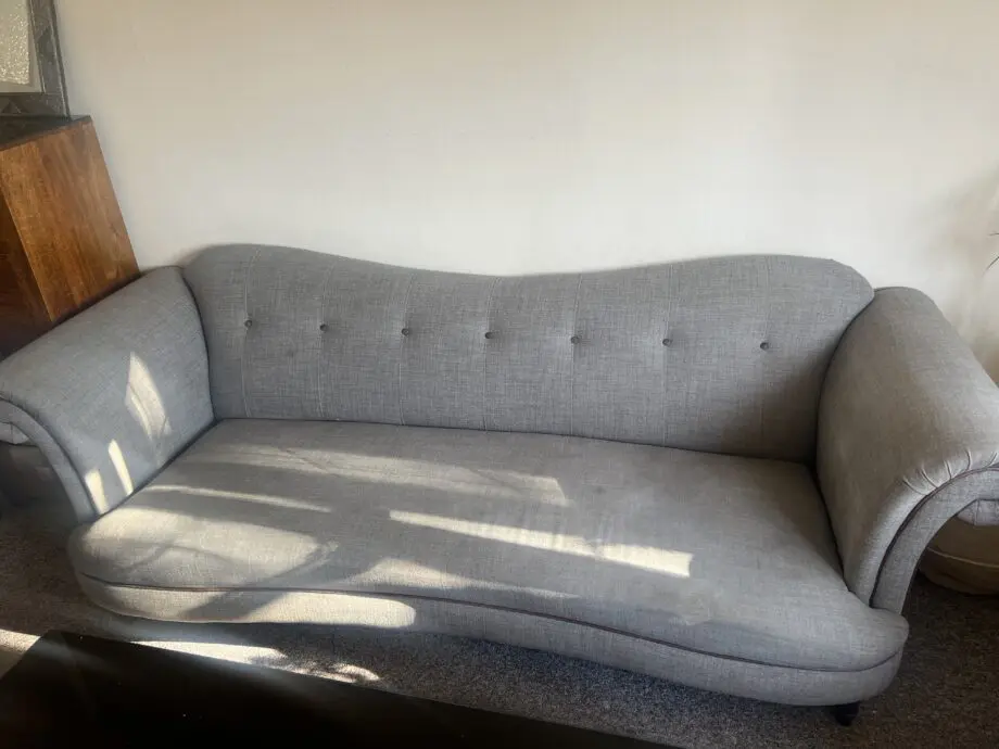 DFS greyish with brown trimming. With dark wood feet.