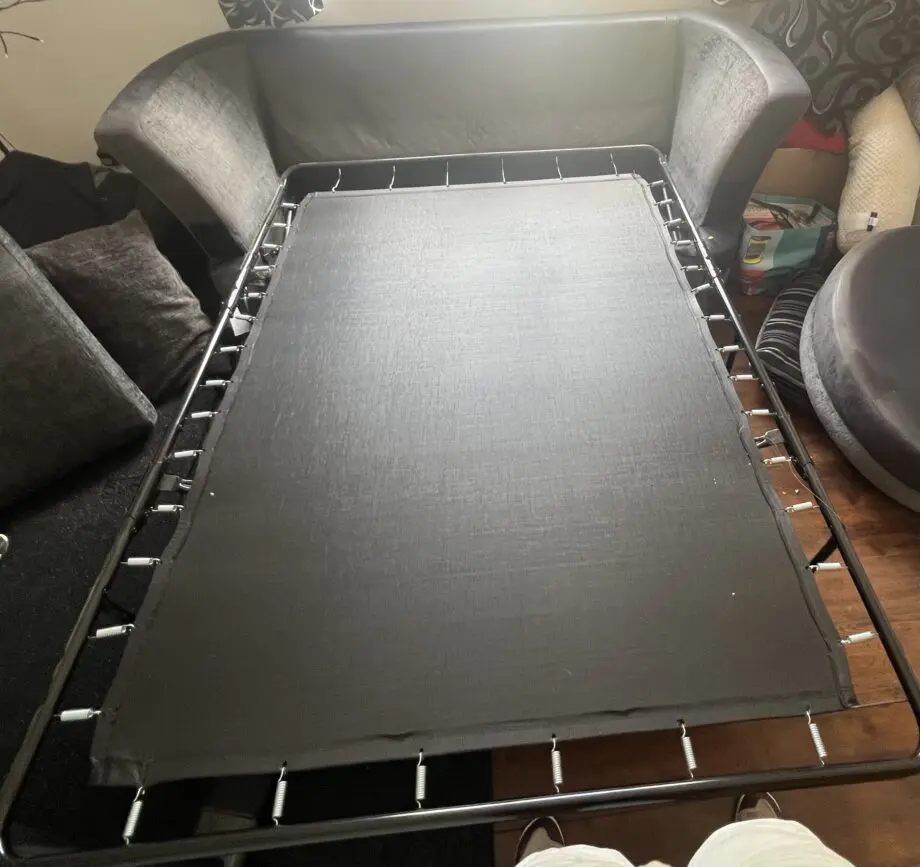 Dark grey and black sofa bed with cushions