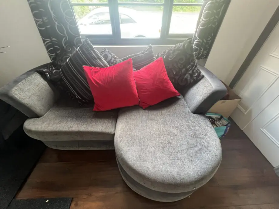 Dark grey and black sofa bed with cushions