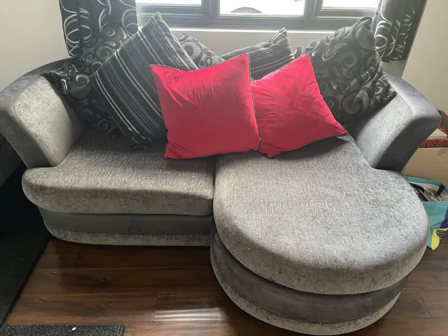 Dark grey and black sofa bed with cushions