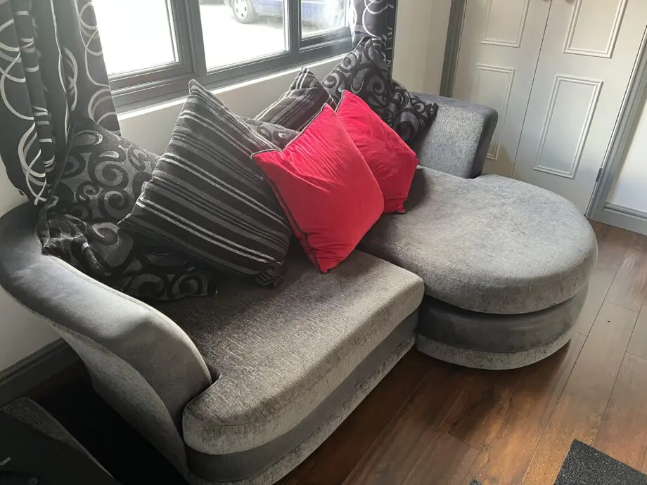 Dark grey and black sofa bed with cushions