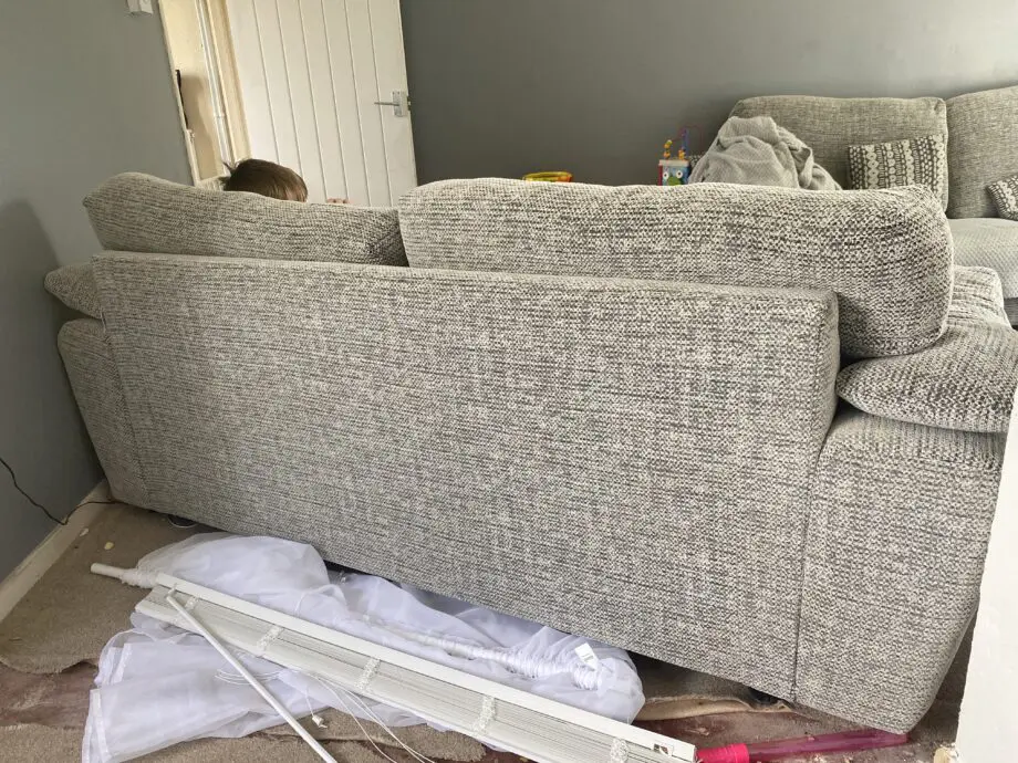 Two 3 seater grey speckled sofas and footstool