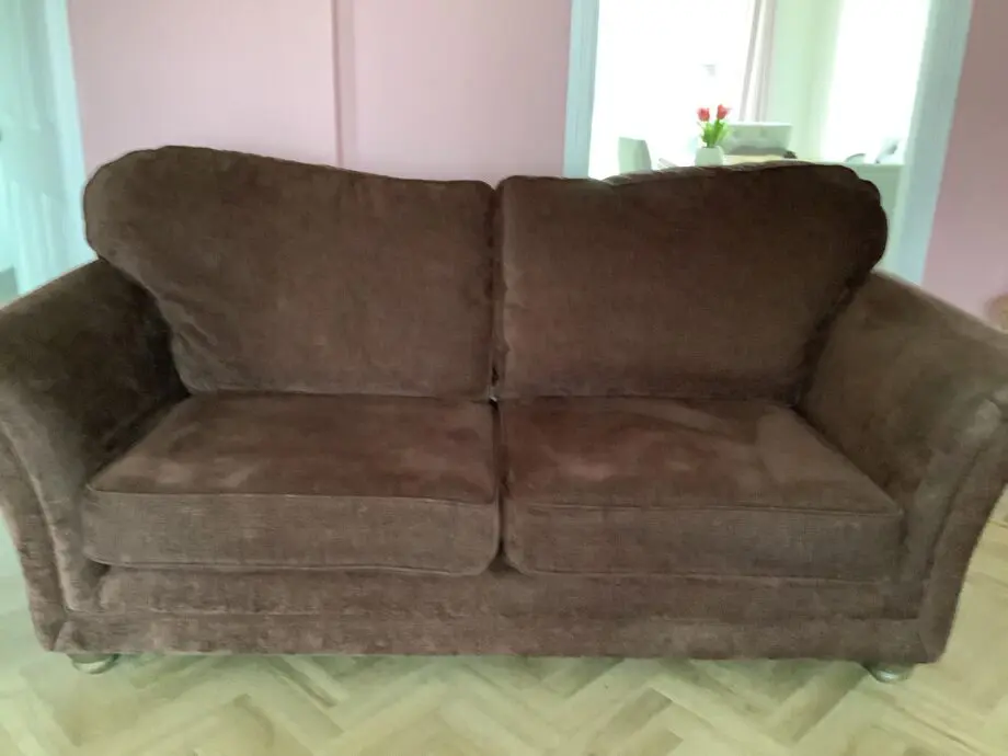 Brown fabric and 4 seater couch with matching chair and footstool.