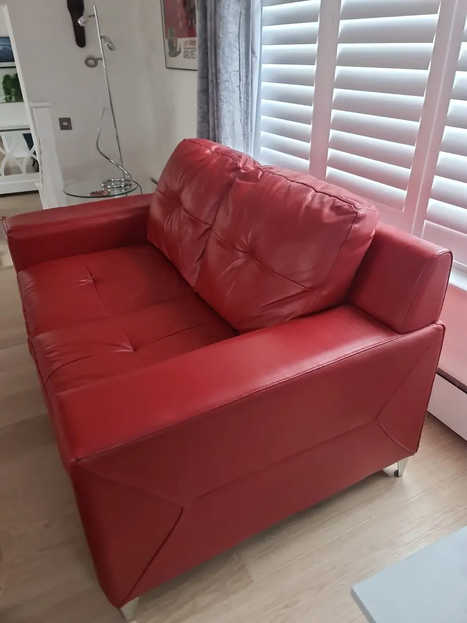 DFS red leather two seater sofa