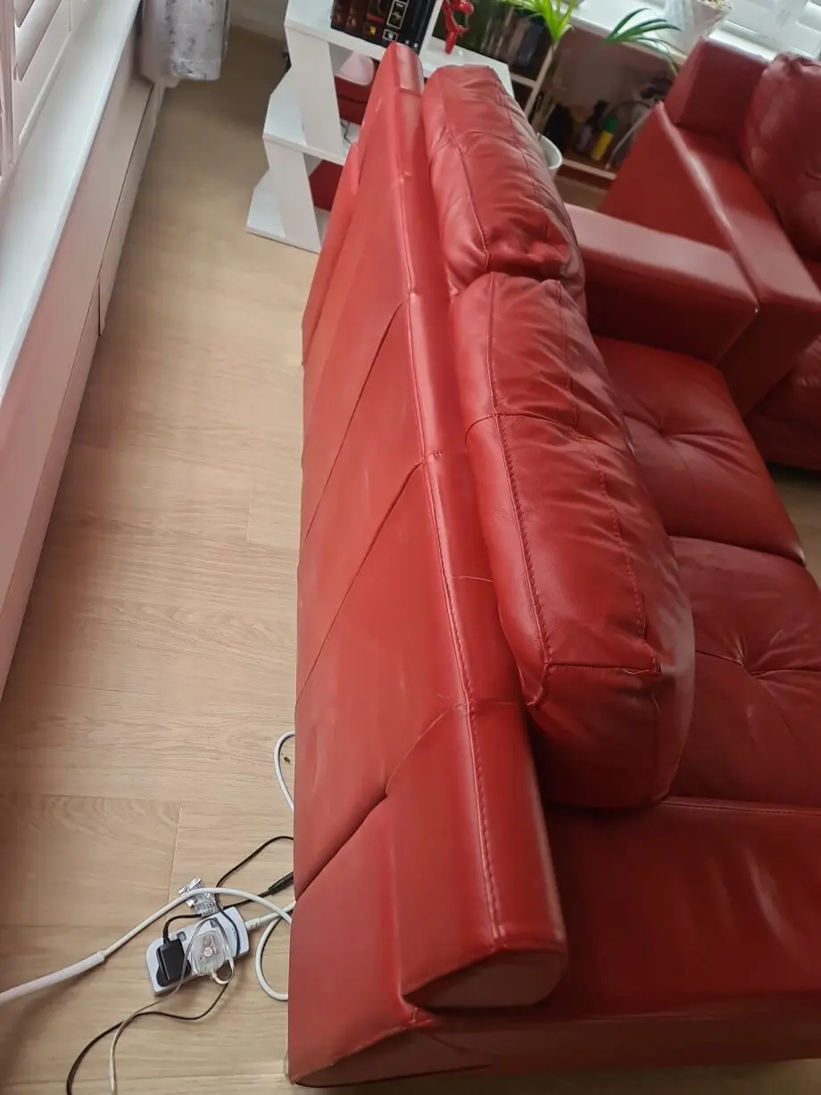 DFS red leather two seater sofa
