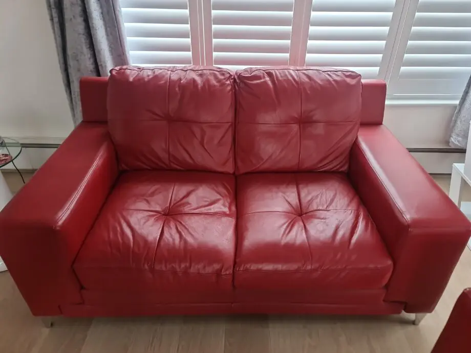 DFS red leather two seater sofa