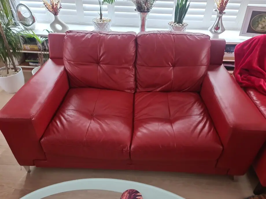 DFS red leather two seater sofa