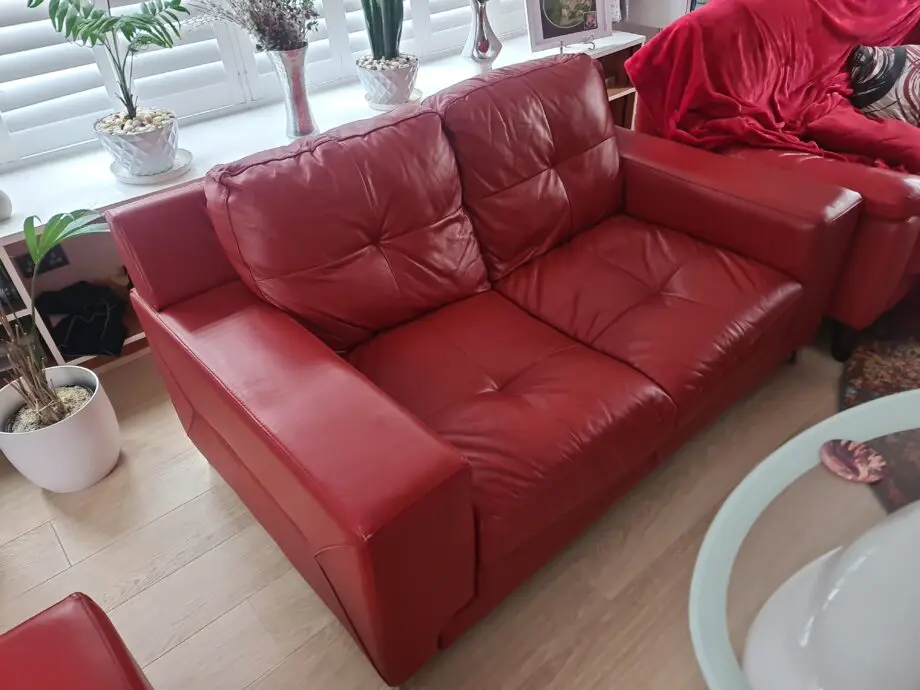 DFS red leather two seater sofa