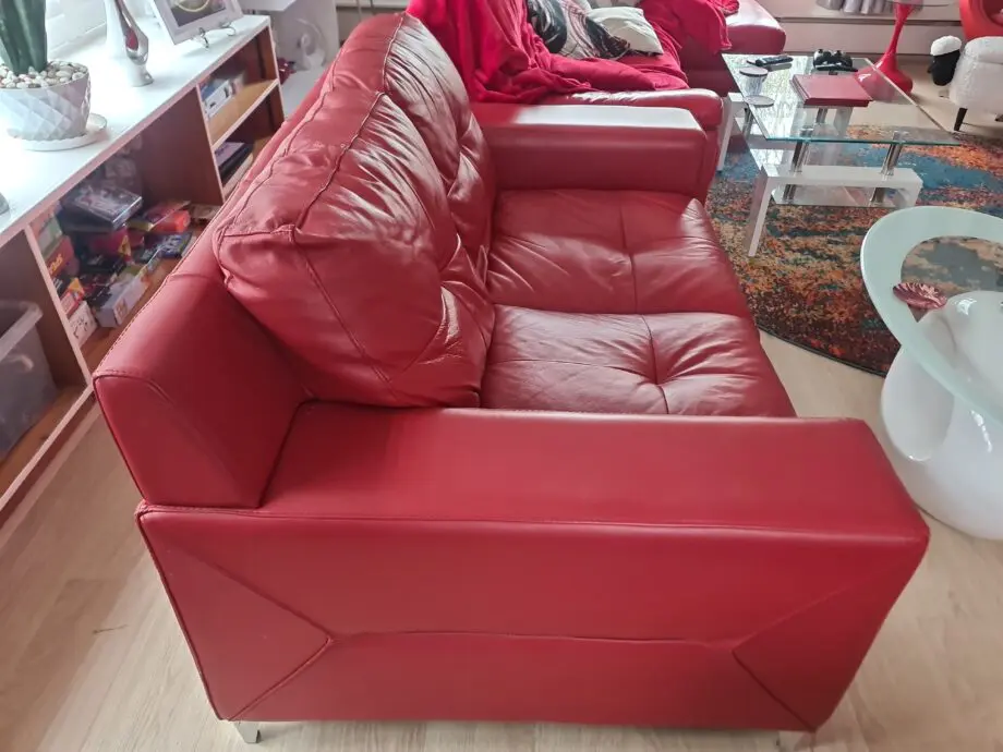 DFS red leather two seater sofa