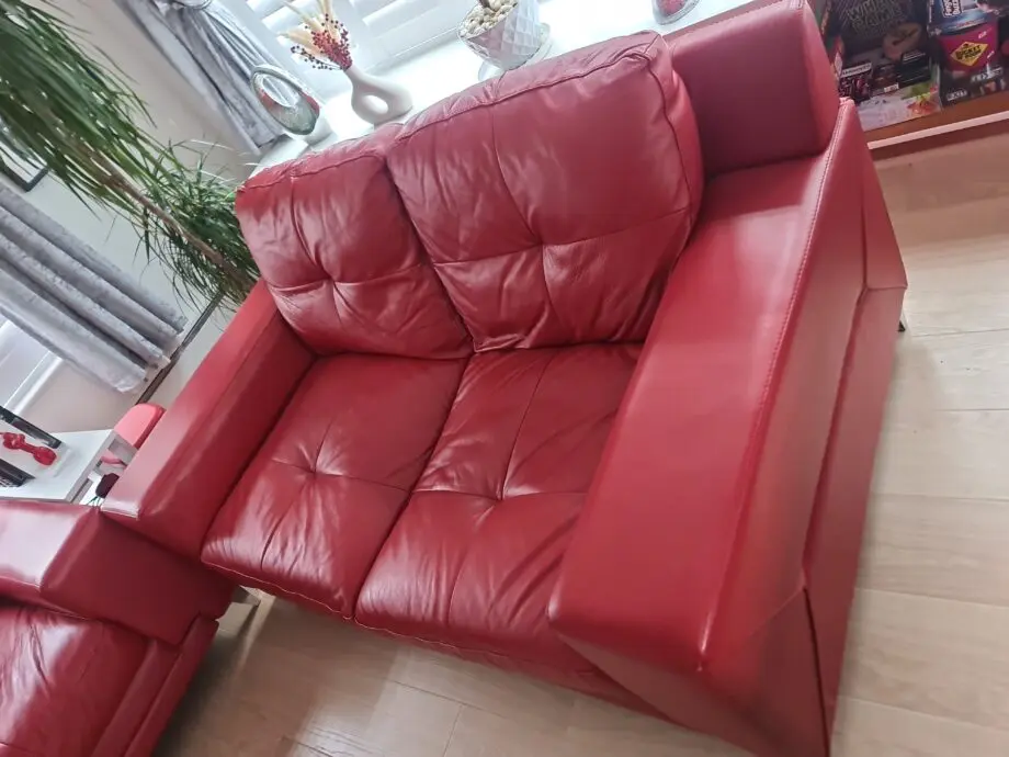 DFS red leather two seater sofa