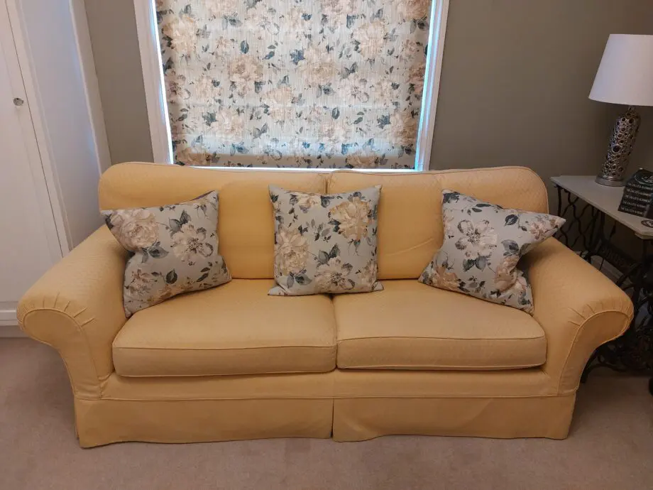 Multiyork, yellow, loose covered sofabed with fire reg label.