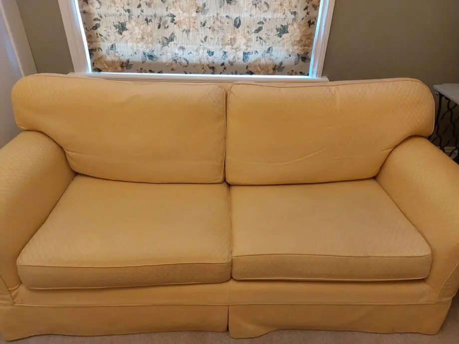 Multiyork, yellow, loose covered sofabed with fire reg label.
