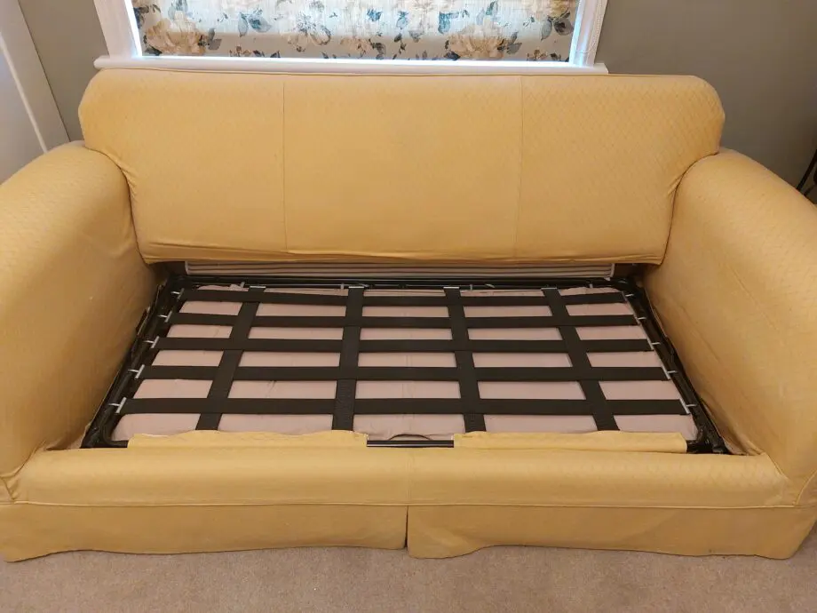 Multiyork, yellow, loose covered sofabed with fire reg label.