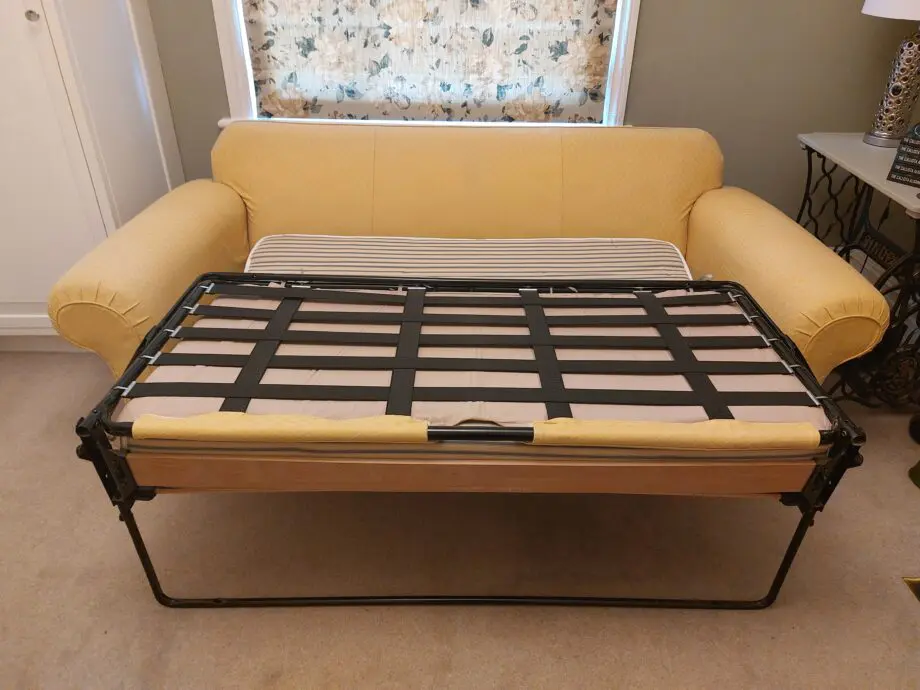 Multiyork, yellow, loose covered sofabed with fire reg label.