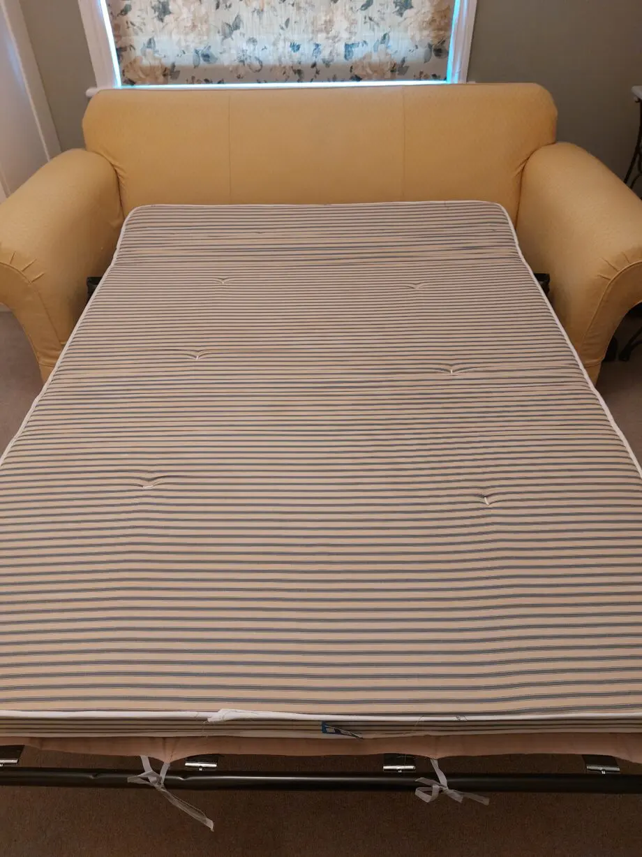 Multiyork, yellow, loose covered sofabed with fire reg label.