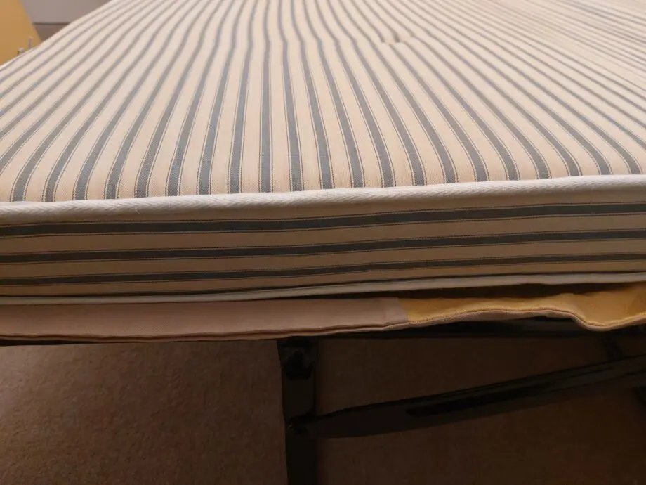 Multiyork, yellow, loose covered sofabed with fire reg label.