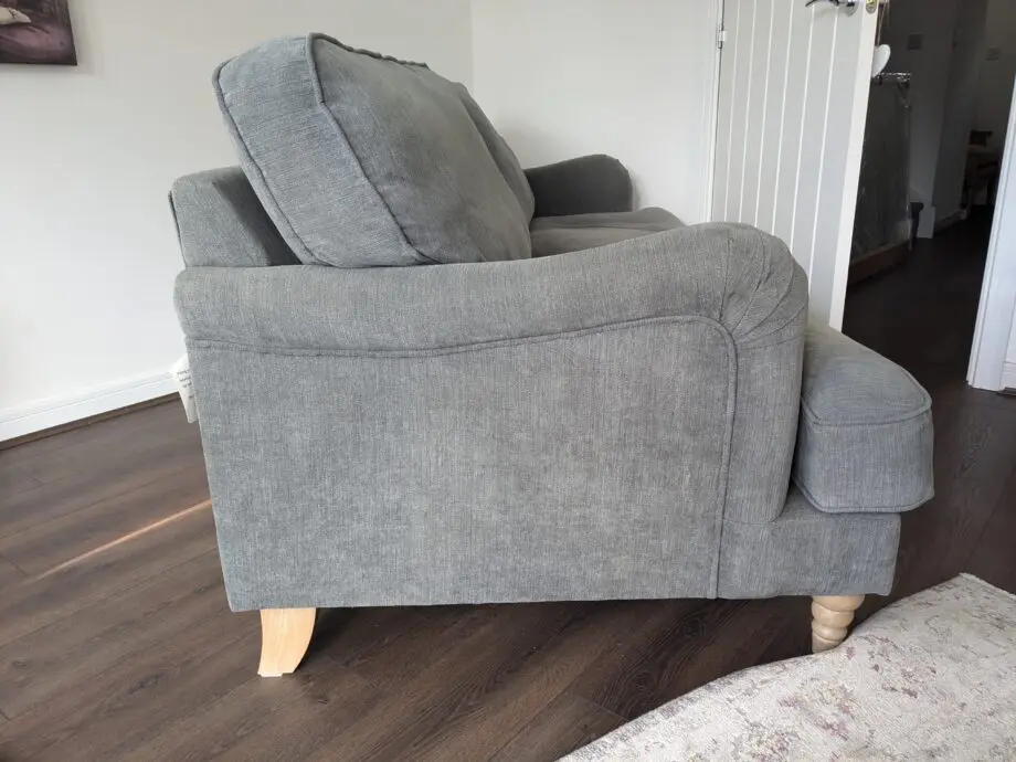 Grey sofa with removable covers and wood spindle legs. Lovely sofa and very comfortable.