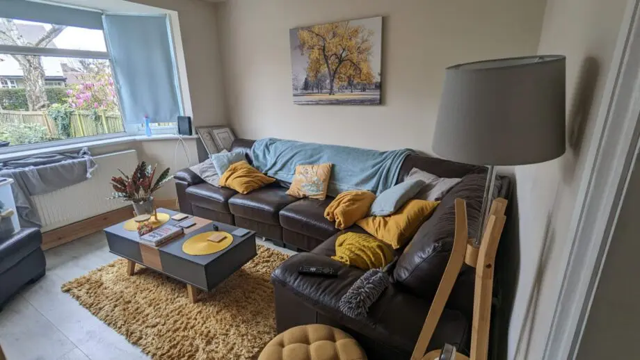DFS brown leather corner sofa and footstool