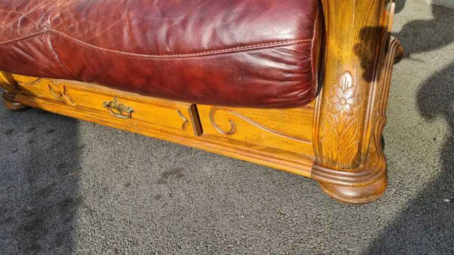 Maroon 2 seater leather sofa.