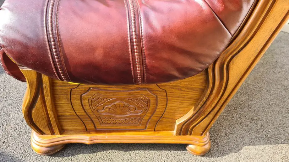 Maroon 2 seater leather sofa.