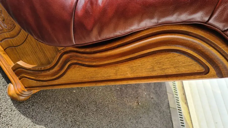 Maroon 2 seater leather sofa.