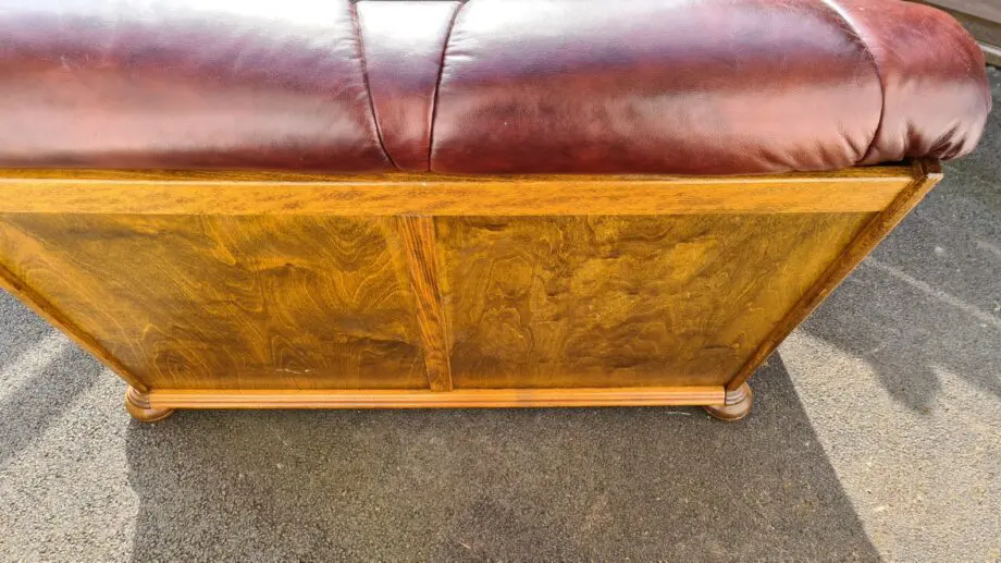 Maroon 2 seater leather sofa.