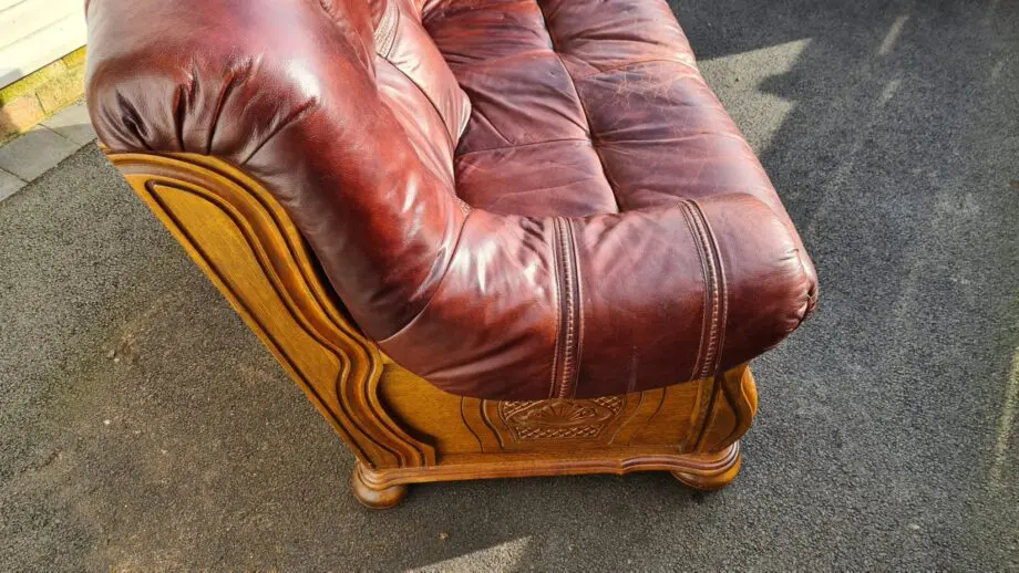 Maroon 2 seater leather sofa.