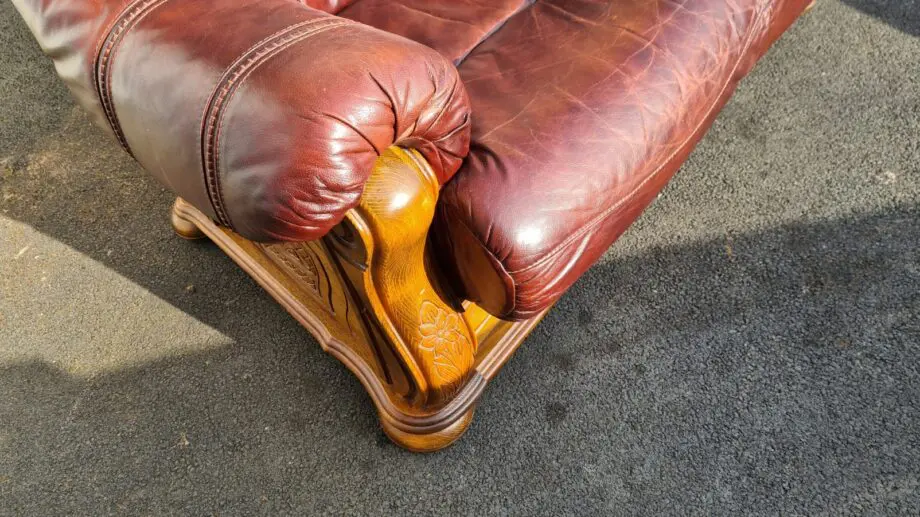 Maroon 2 seater leather sofa.
