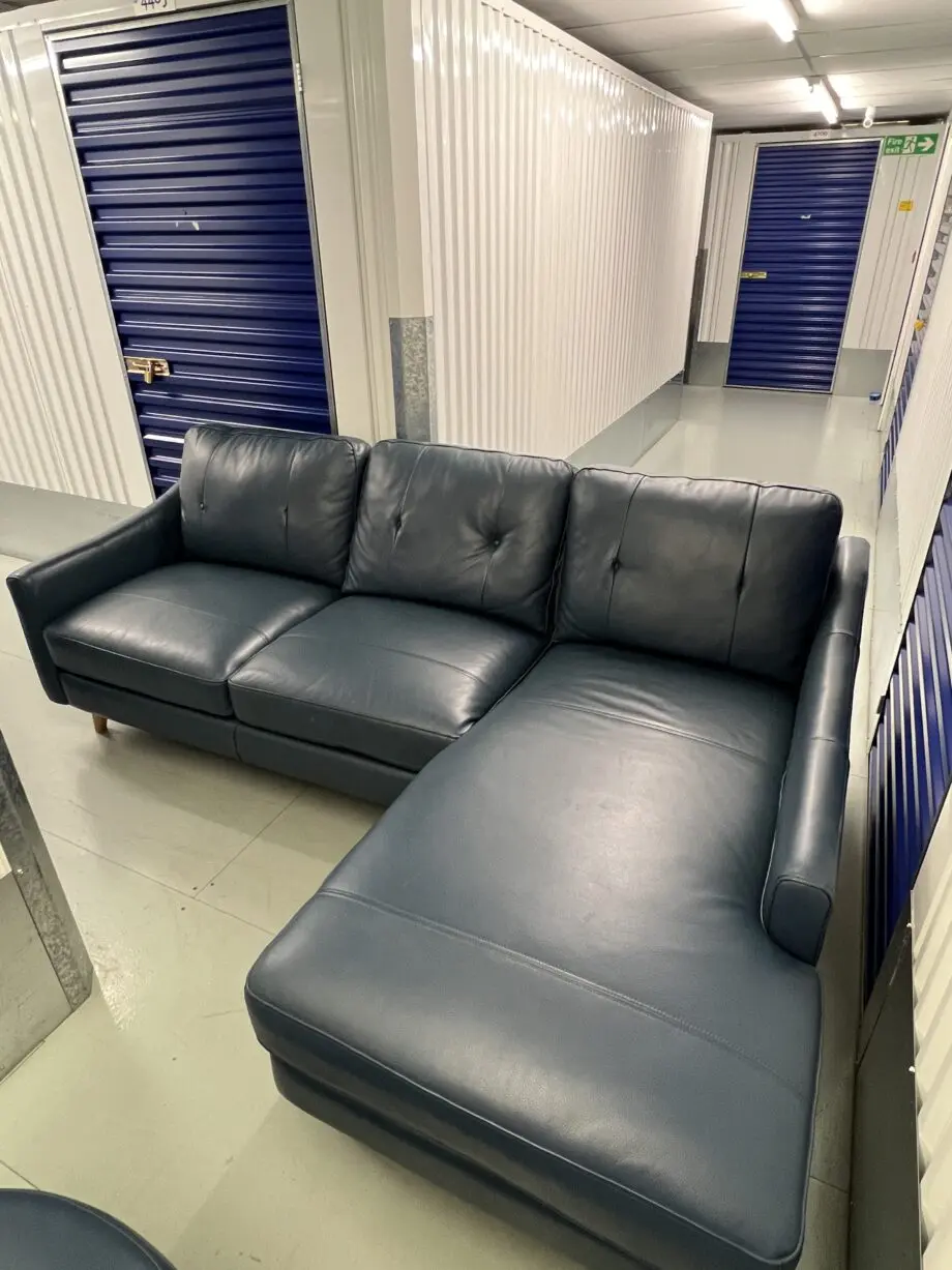 Blue leather sofa and matching footstool