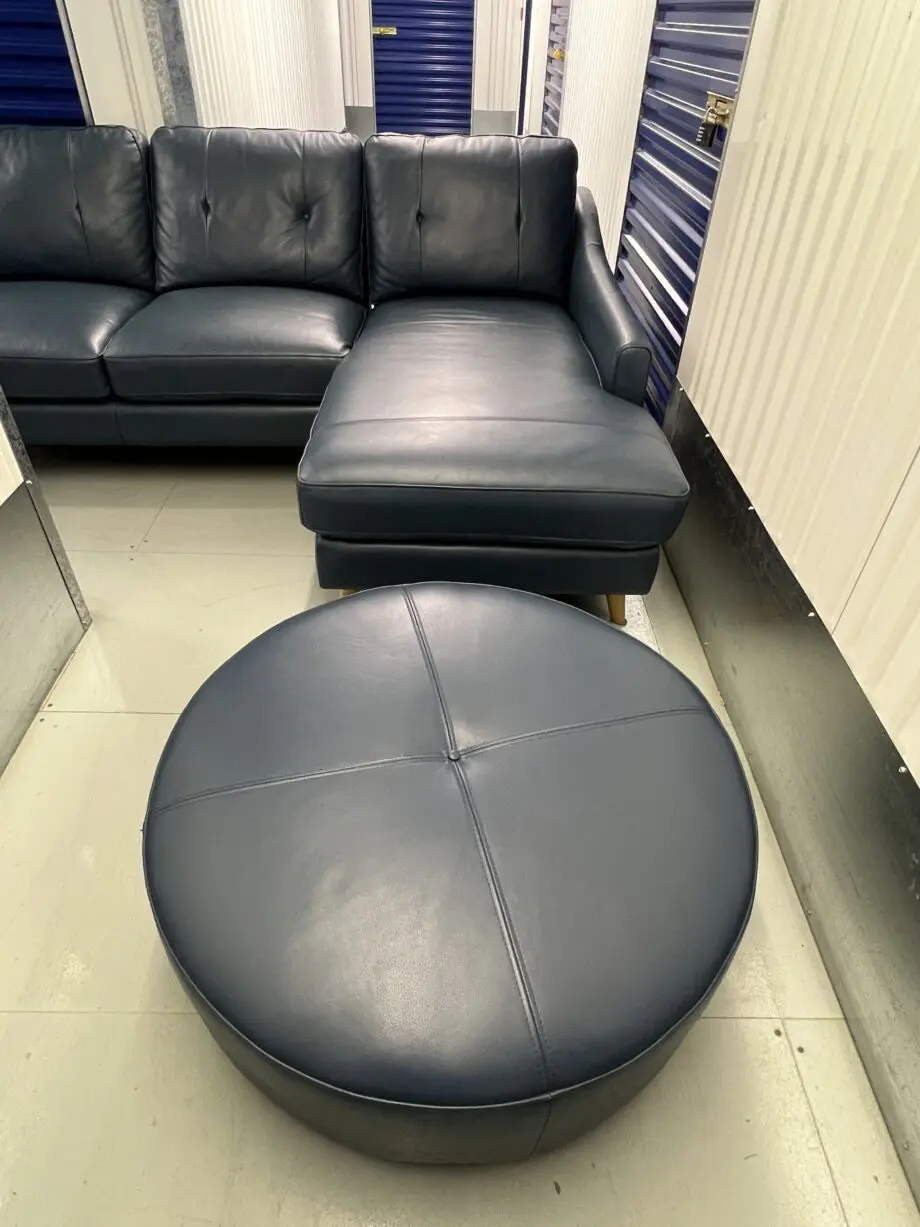 Blue leather sofa and matching footstool